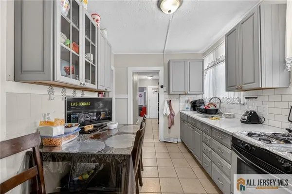 a kitchen with granite countertop a sink appliances cabinets and counter space