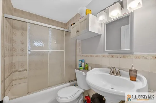 a kitchen with white cabinets and appliances