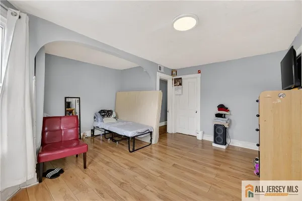 a view of a hallway with entryway and wooden floor