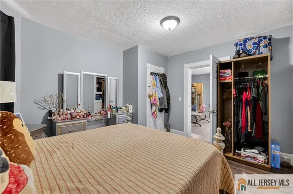 a bedroom with bed and a flat tv screen