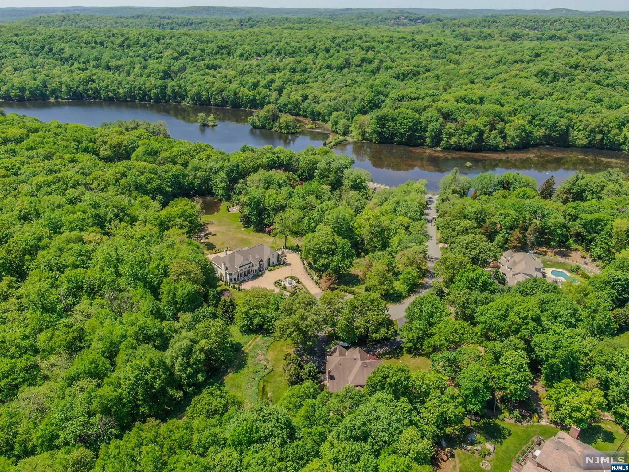 9 Vista Court Butler, NJ 07405 - Photo 8 of 11 an aerial view of residential houses with outdoor space and trees all around