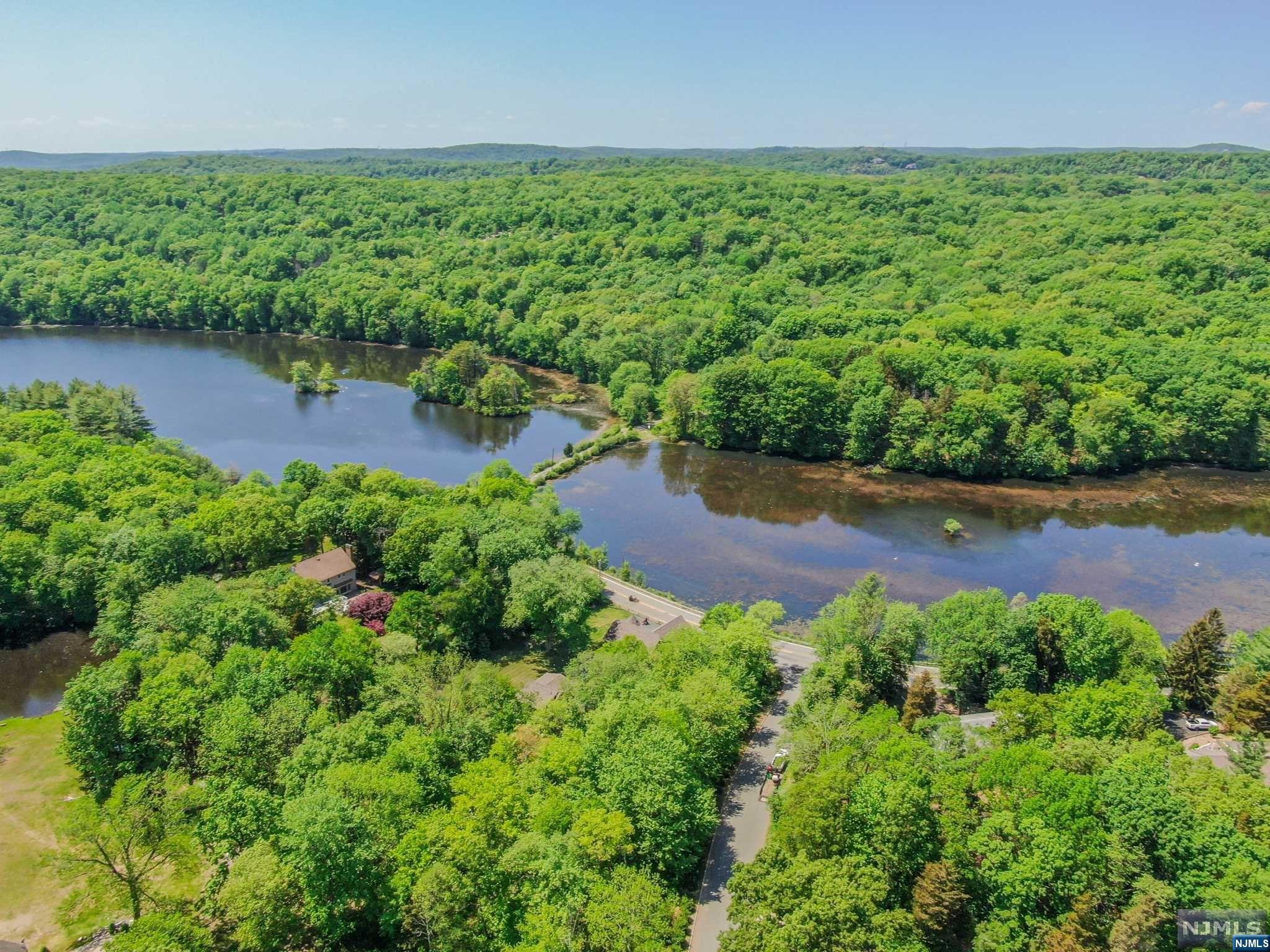 9 Vista Court Butler, NJ 07405 - Photo 9 of 11 a view of a garden with lawn chairs and large trees