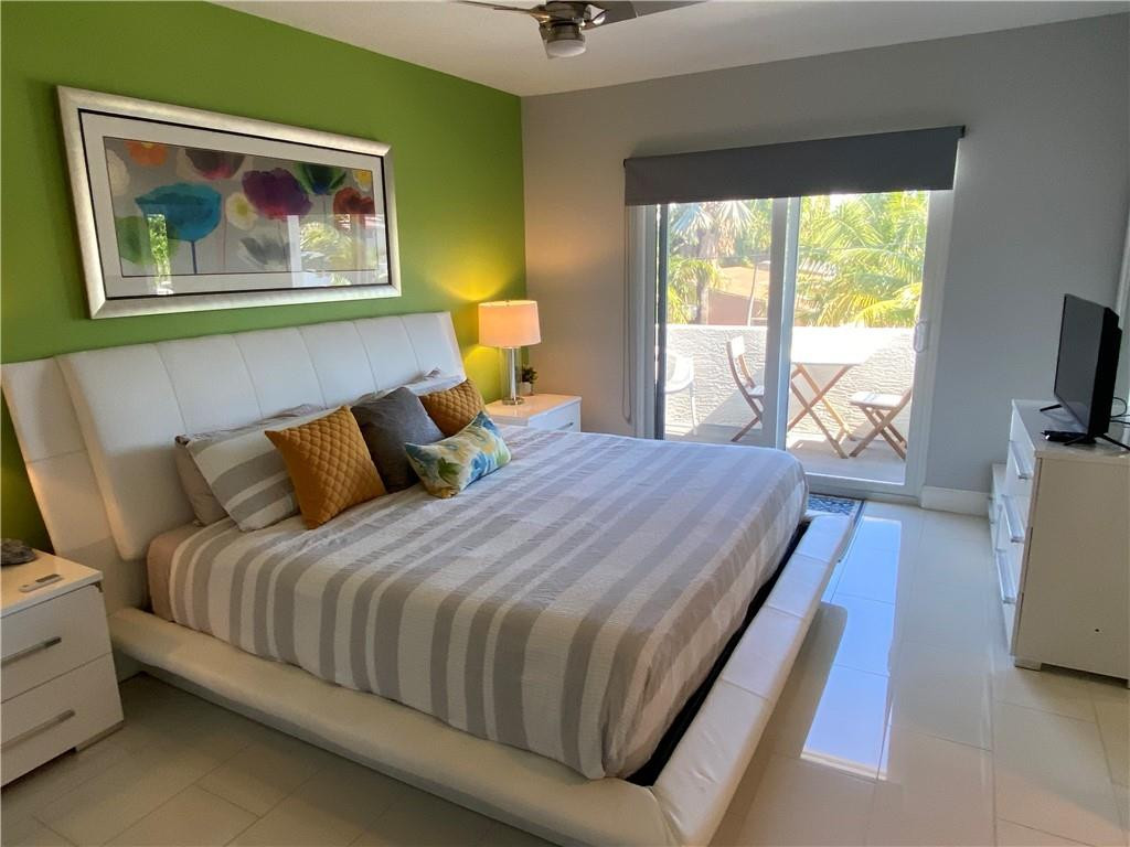 1705 North Riverside Drive, Unit 5 Pompano Beach, FL 33062 - Photo 11 of 24 a bedroom with bed and wooden floor