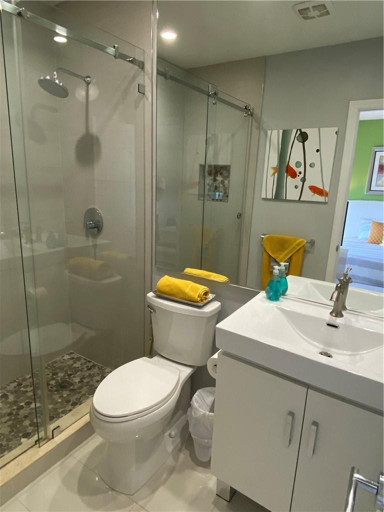 1705 North Riverside Drive, Unit 5 Pompano Beach, FL 33062 - Photo 13 of 24 a bathroom with a sink a toilet and shower