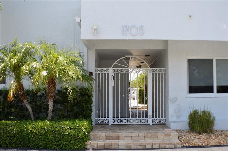 1705 North Riverside Drive, Unit 5 Pompano Beach, FL 33062 - Photo 2 of 24 a front view of a house with garden