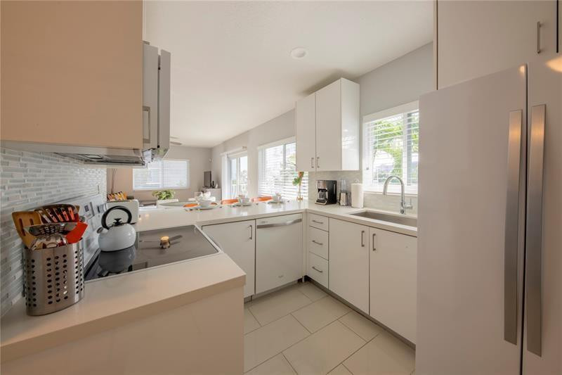 1705 North Riverside Drive, Unit 5 Pompano Beach, FL 33062 - Photo 6 of 24 a kitchen with stainless steel appliances granite countertop a sink and cabinets