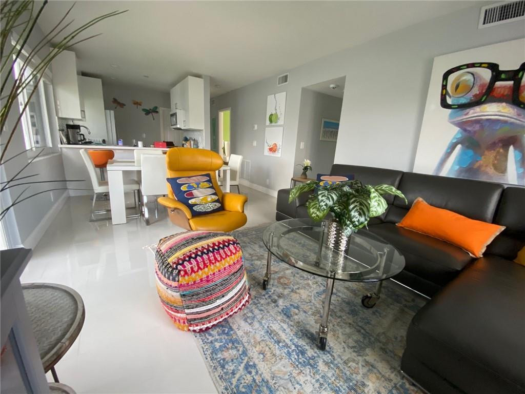 1705 North Riverside Drive, Unit 5 Pompano Beach, FL 33062 - Photo 10 of 24 a living room with rug furniture and a rug