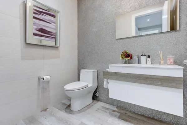 a bathroom with a toilet sink and vanity