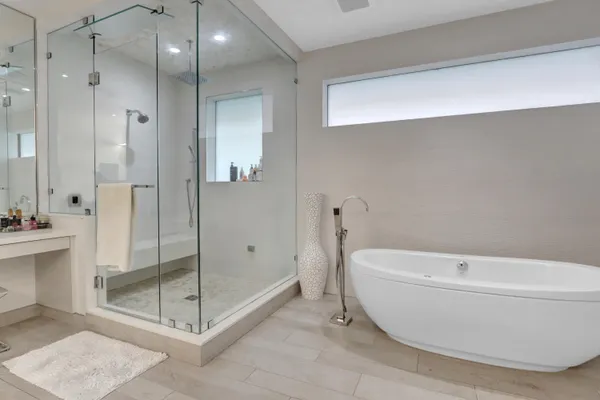 a bathroom with a bathtub and a shower
