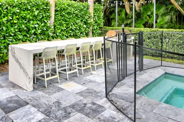 a view of a patio with table and chairs with wooden floor and fence