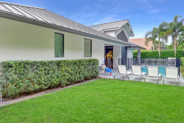 a front view of a house with a garden and patio