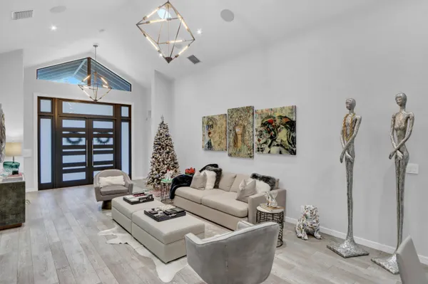 a living room with furniture and wooden floor