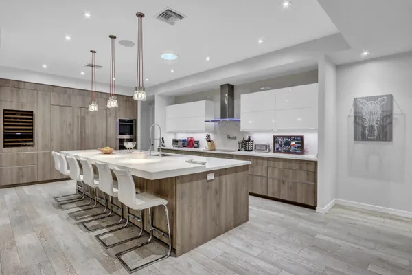 a kitchen with stainless steel appliances kitchen island a island in the center and wooden floors