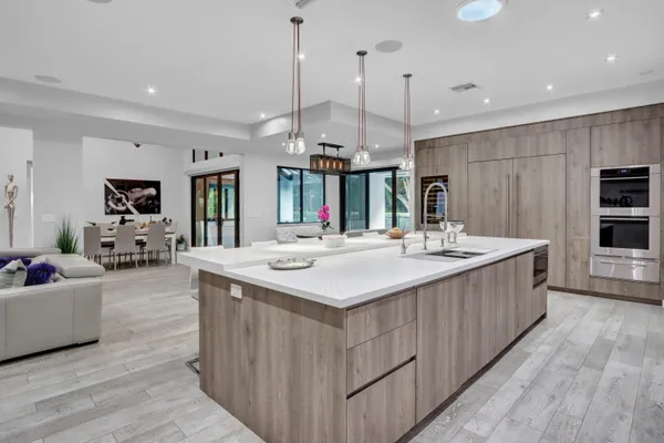 a kitchen with kitchen island a sink and a large refrigerator
