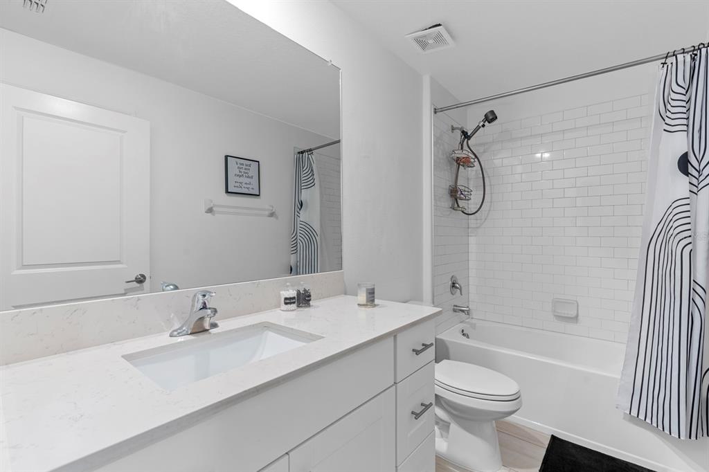 13124 Merlot Sunstone Cove Parrish, FL 34219 - Photo 20 of 45 a bathroom with a sink toilet tub and shower