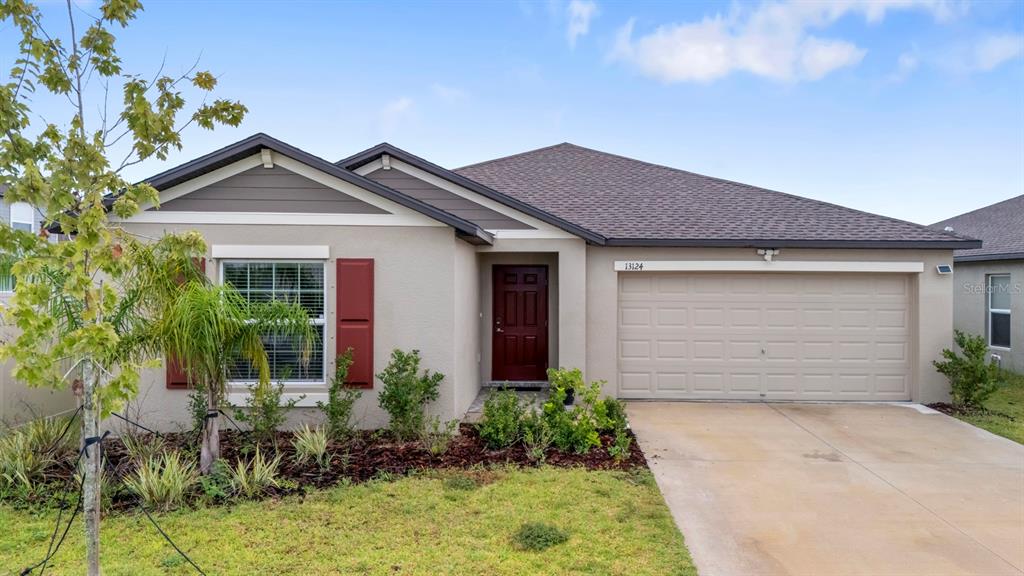 13124 Merlot Sunstone Cove Parrish, FL 34219 - Photo 2 of 45 front view of house with potted plants