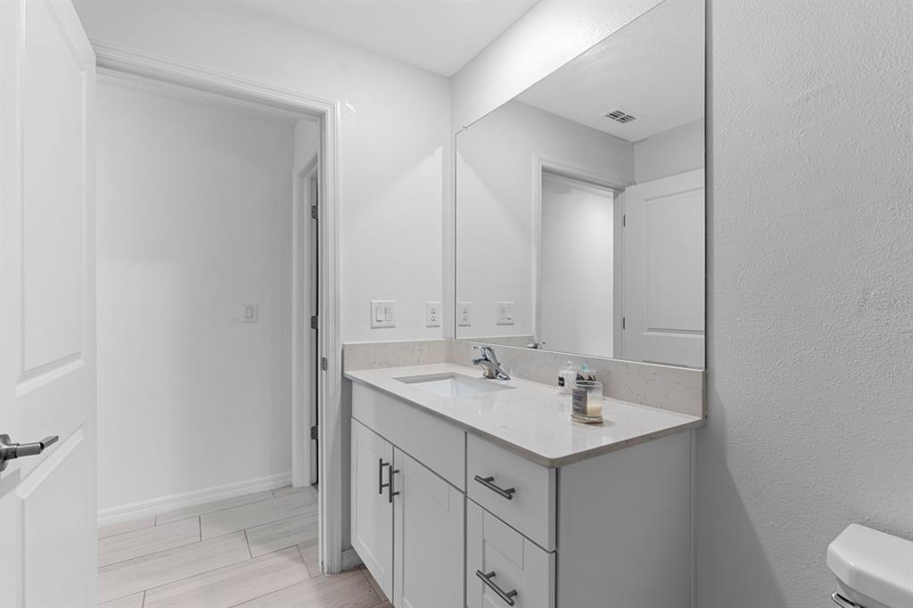 13124 Merlot Sunstone Cove Parrish, FL 34219 - Photo 21 of 45 a bathroom with a sink and a mirror