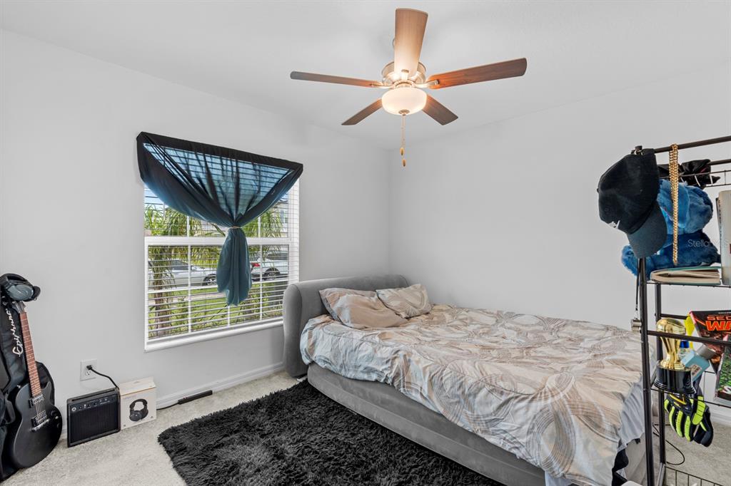 13124 Merlot Sunstone Cove Parrish, FL 34219 - Photo 22 of 45 a bedroom with a bed and a window