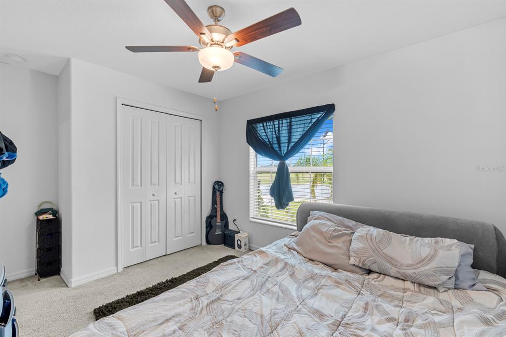 13124 Merlot Sunstone Cove Parrish, FL 34219 - Photo 23 of 45 a bedroom with a bed and a window