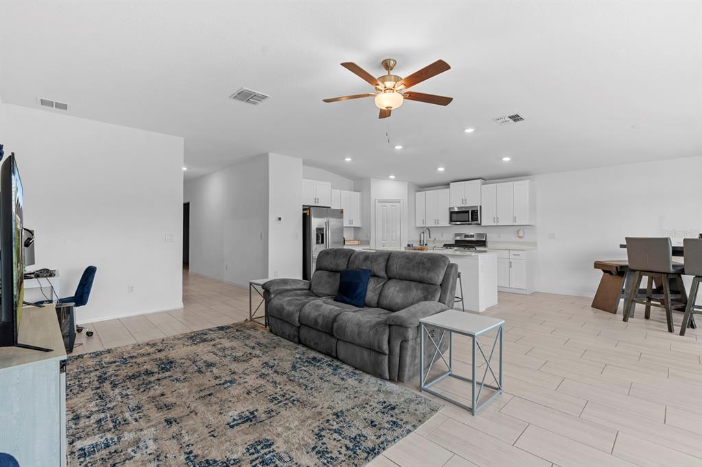 13124 Merlot Sunstone Cove Parrish, FL 34219 - Photo 31 of 45 a living room with furniture and kitchen view