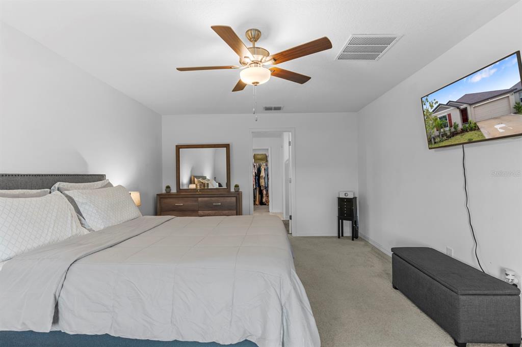 13124 Merlot Sunstone Cove Parrish, FL 34219 - Photo 35 of 45 a bedroom with a bed and window