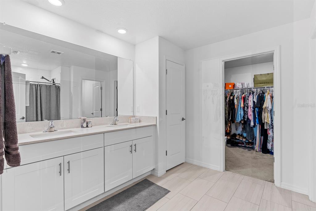 13124 Merlot Sunstone Cove Parrish, FL 34219 - Photo 36 of 45 a bathroom with a double vanity sink and a mirror
