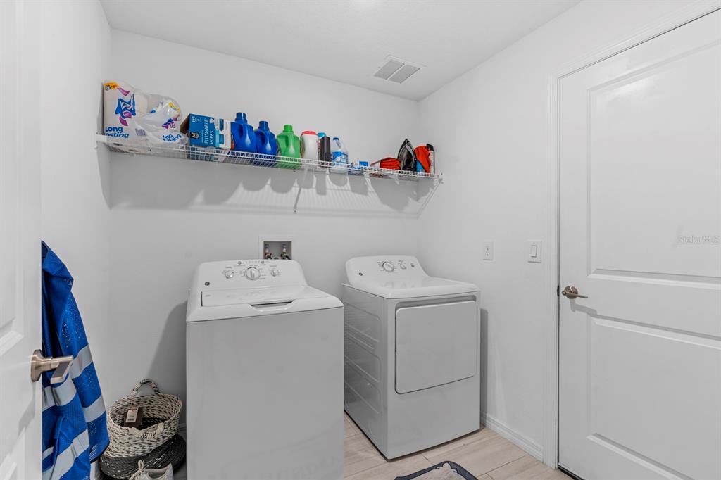 13124 Merlot Sunstone Cove Parrish, FL 34219 - Photo 39 of 45 a utility room with dryer and washer