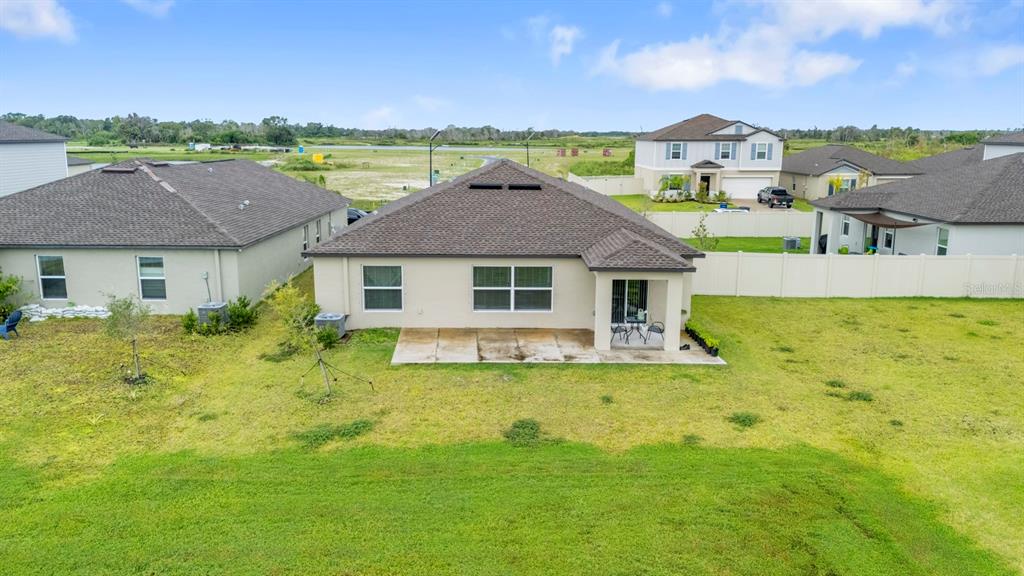 13124 Merlot Sunstone Cove Parrish, FL 34219 - Photo 40 of 45 a view of a house with pool and a yard