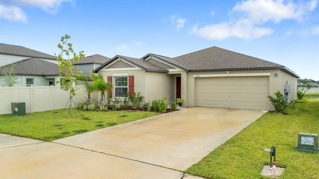 13124 Merlot Sunstone Cove Parrish, FL 34219 - Photo 4 of 45 a front view of a house with garden
