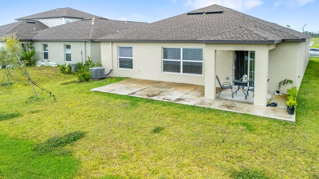 13124 Merlot Sunstone Cove Parrish, FL 34219 - Photo 41 of 45 a front view of house with yard and outdoor seating