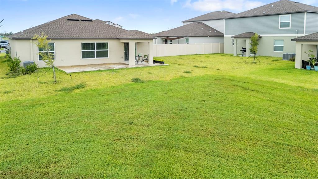 13124 Merlot Sunstone Cove Parrish, FL 34219 - Photo 42 of 45 a front door view of a house with a yard