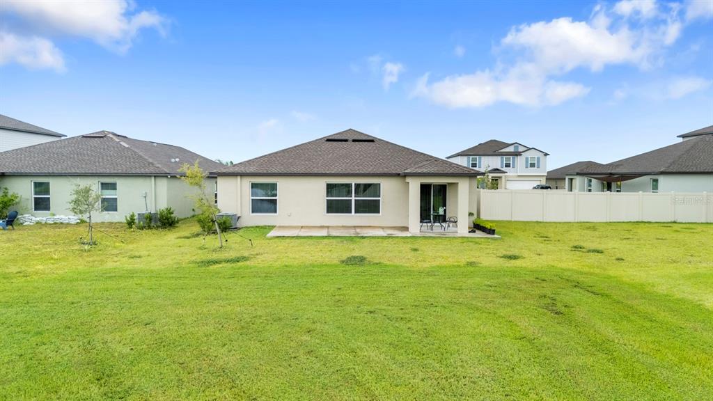 13124 Merlot Sunstone Cove Parrish, FL 34219 - Photo 43 of 45 a front view of a house with swimming pool having outdoor seating