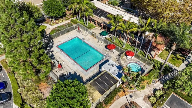 a front view of multi story residential apartment building with yard and retail shops