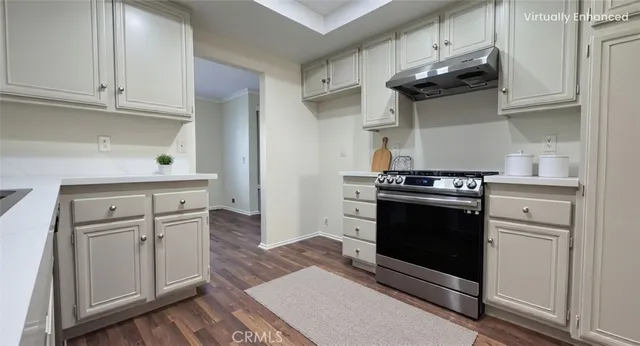 a kitchen with white cabinets and appliances