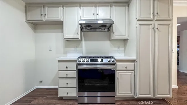 a stove top oven sitting inside of a kitchen