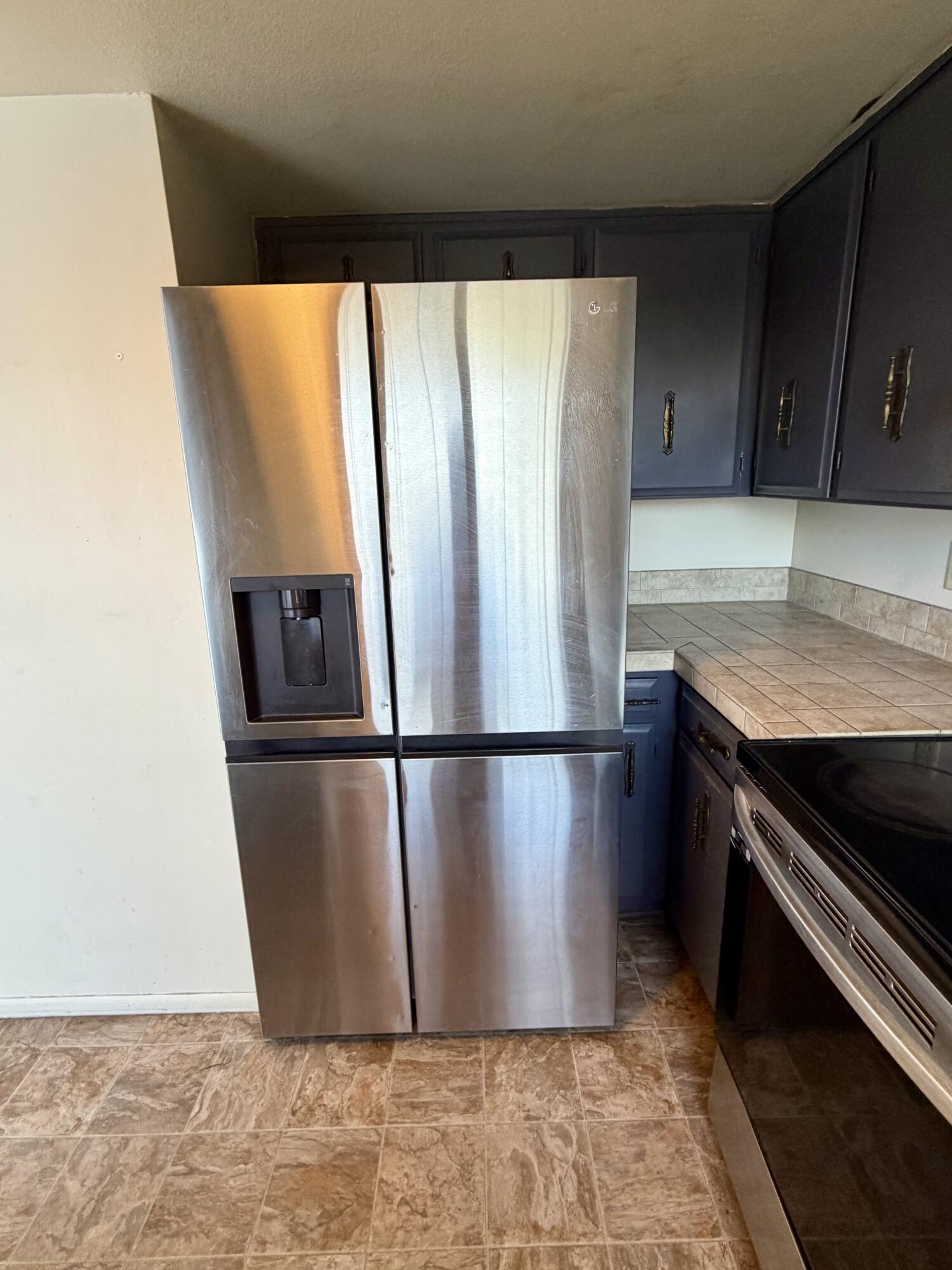 1198 Morrow Road, Unit A Medford, OR 97504 - Photo 12 of 20 a view of a kitchen with a refrigerator wooden floor and cabinets