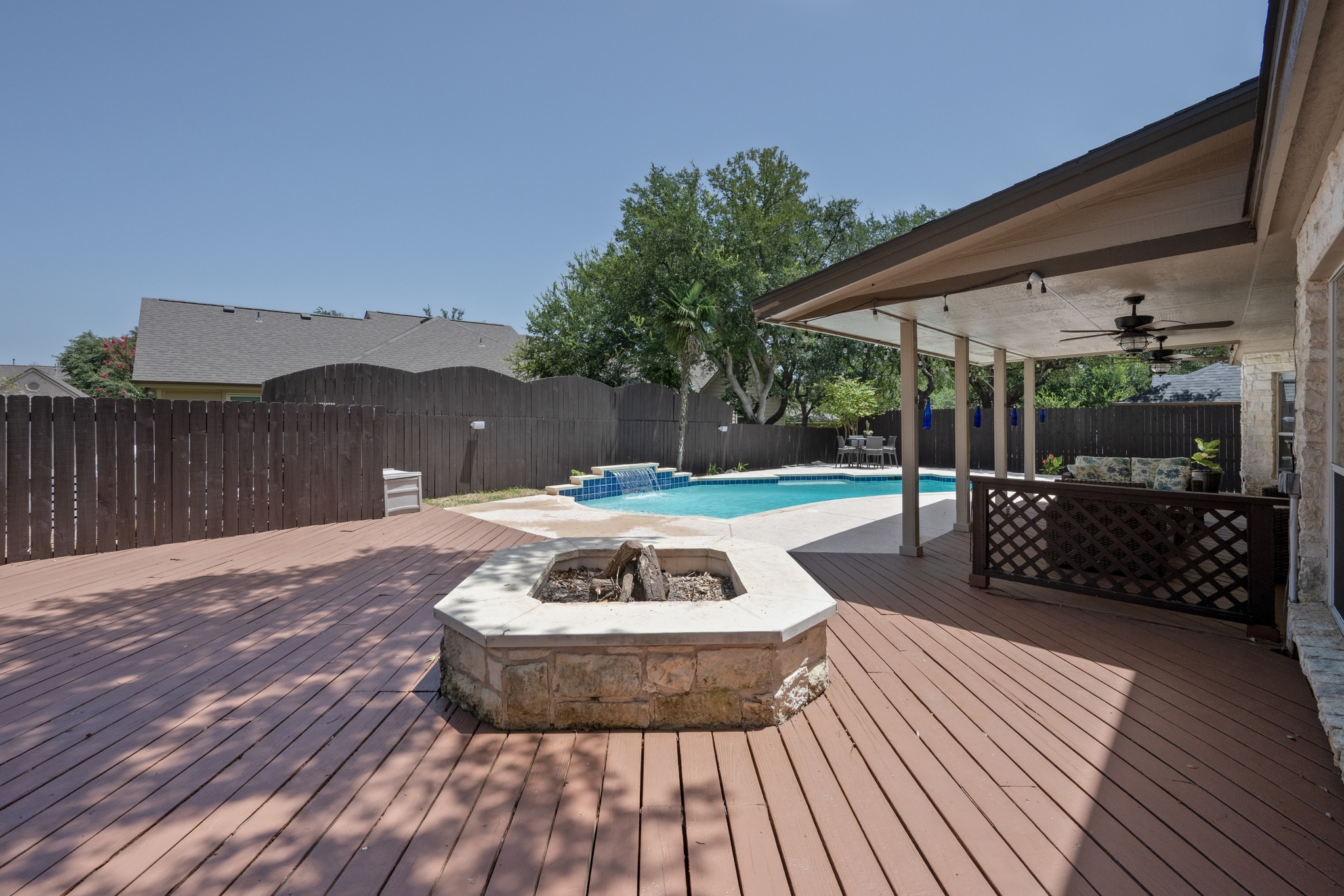 108 Thornwood Road Georgetown, TX 78628 - Photo 37 of 40 A spacious wood deck and covered patio lead to a refreshing pool and built-in fire pit.