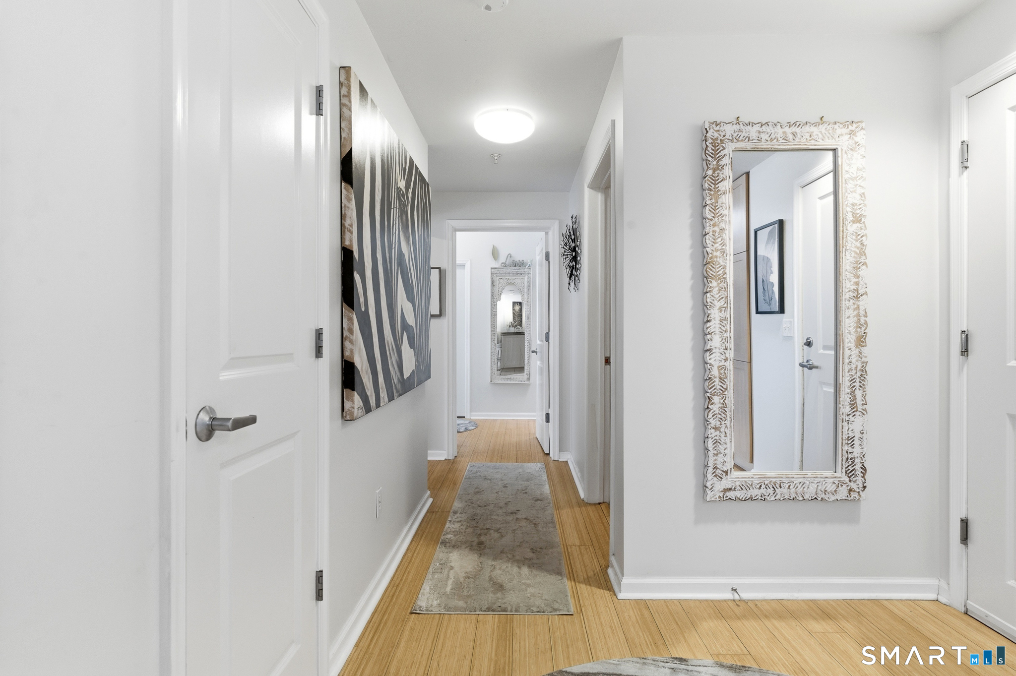 400 Bank Street, Unit 402 New London, CT 06320 - Photo 12 of 35 a view of a hallway with wooden floor and staircase