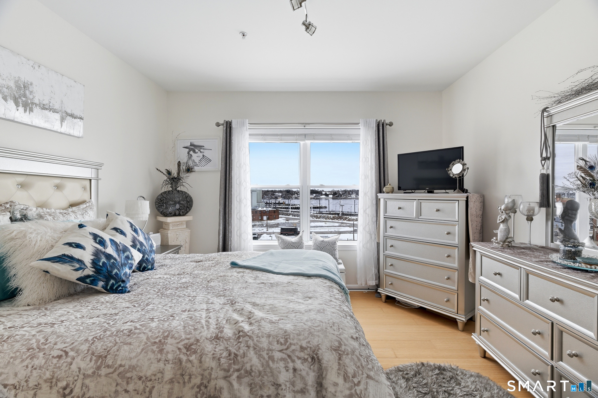 400 Bank Street, Unit 402 New London, CT 06320 - Photo 14 of 35 a bedroom with a bed and flat screen tv