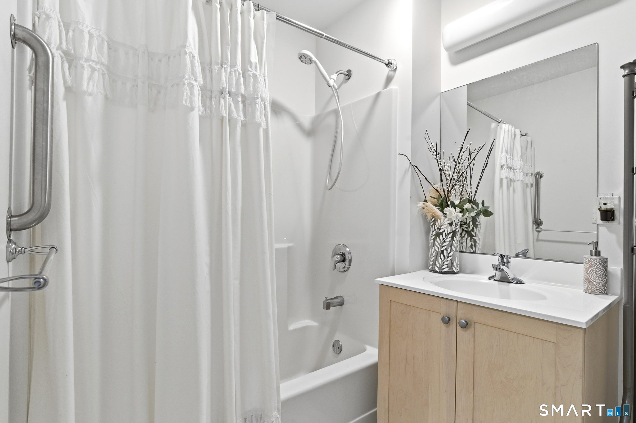 400 Bank Street, Unit 402 New London, CT 06320 - Photo 19 of 35 a bathroom with a sink a mirror and a shower