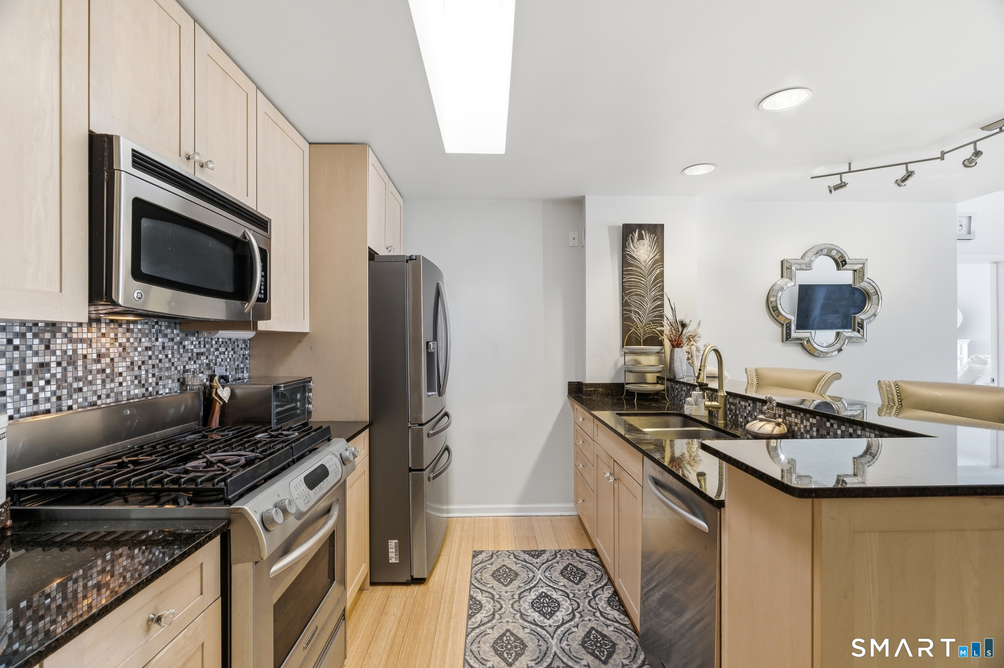 400 Bank Street, Unit 402 New London, CT 06320 - Photo 3 of 35 a kitchen with stainless steel appliances granite countertop a stove a sink dishwasher and a refrigerator
