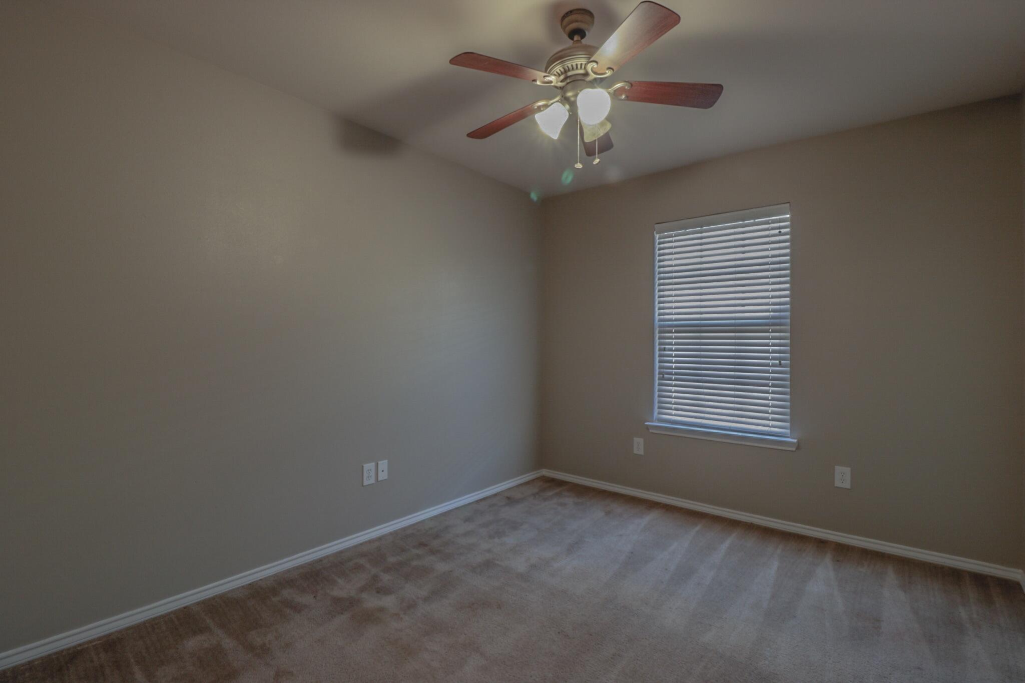 6808 88th Street Lubbock, TX 79424 - Photo 11 of 17 an empty room with a window