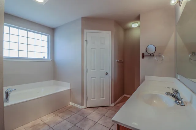 a bathroom with a tub and a sink