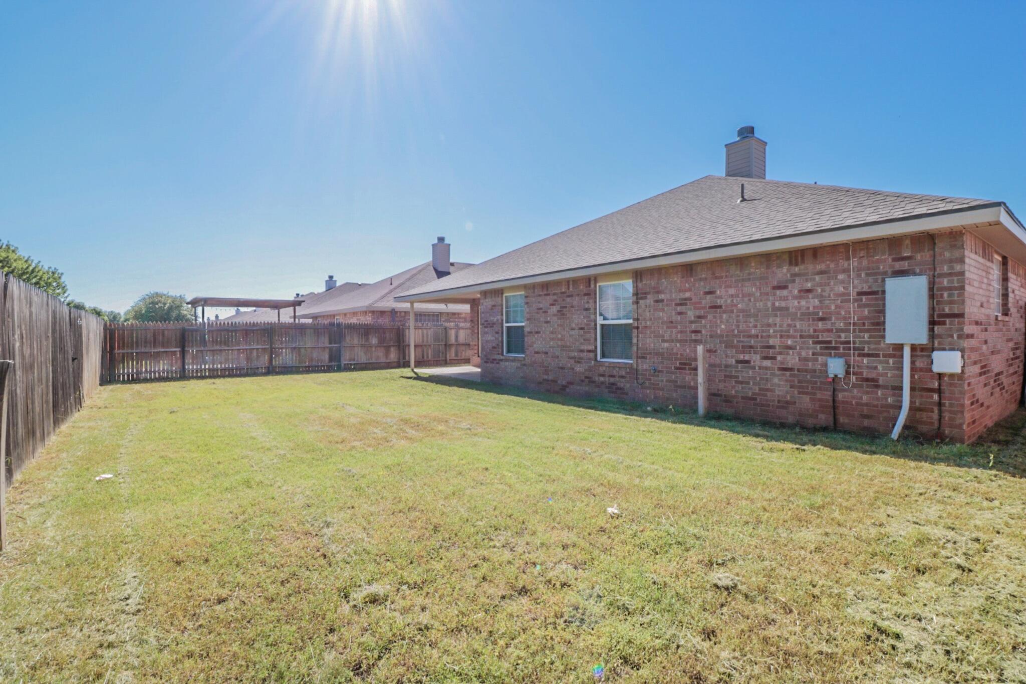 6808 88th Street Lubbock, TX 79424 - Photo 17 of 17 a front view of a house with a yard