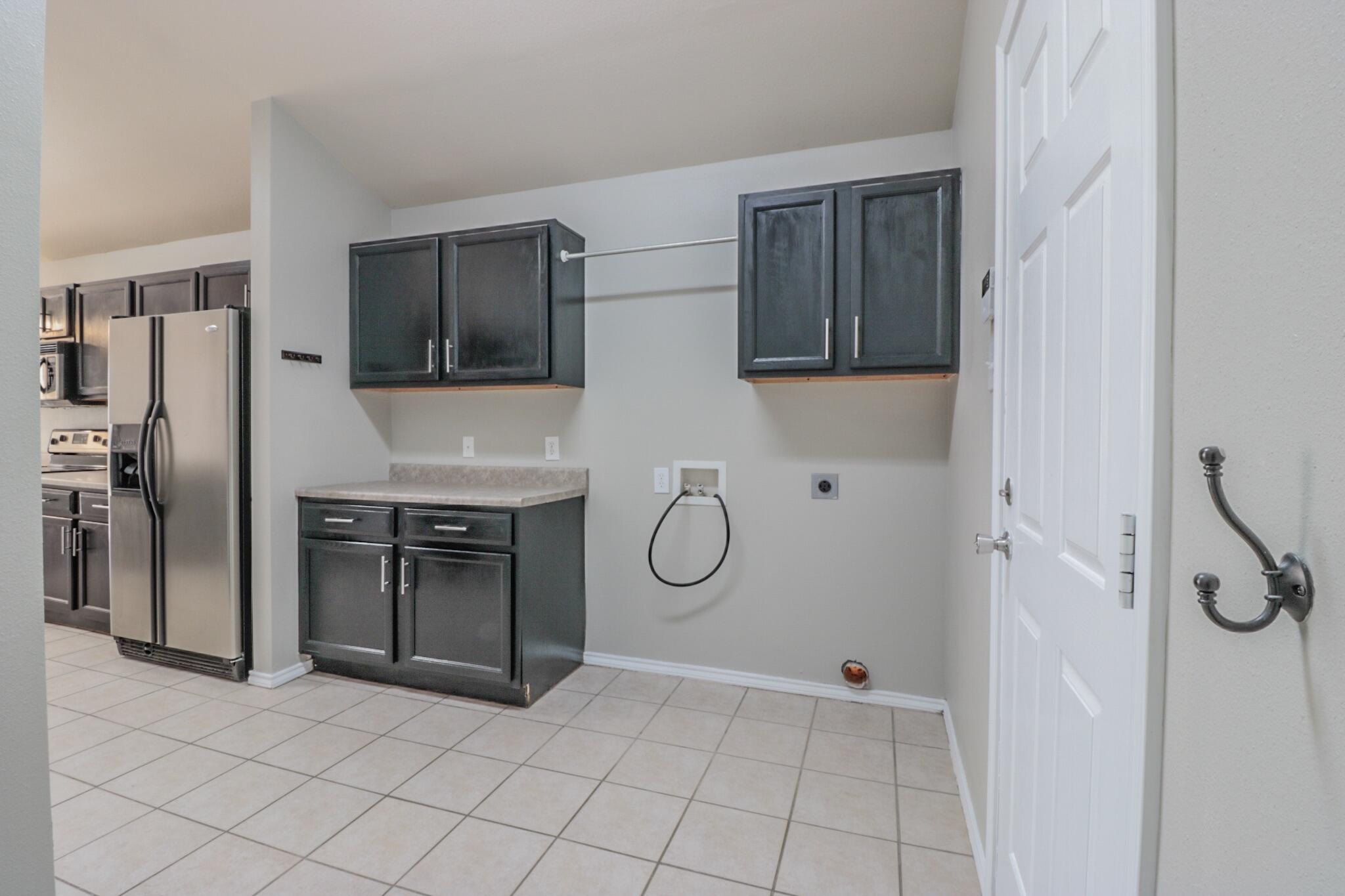 6808 88th Street Lubbock, TX 79424 - Photo 6 of 17 a bathroom with a granite countertop shower a sink and a mirror