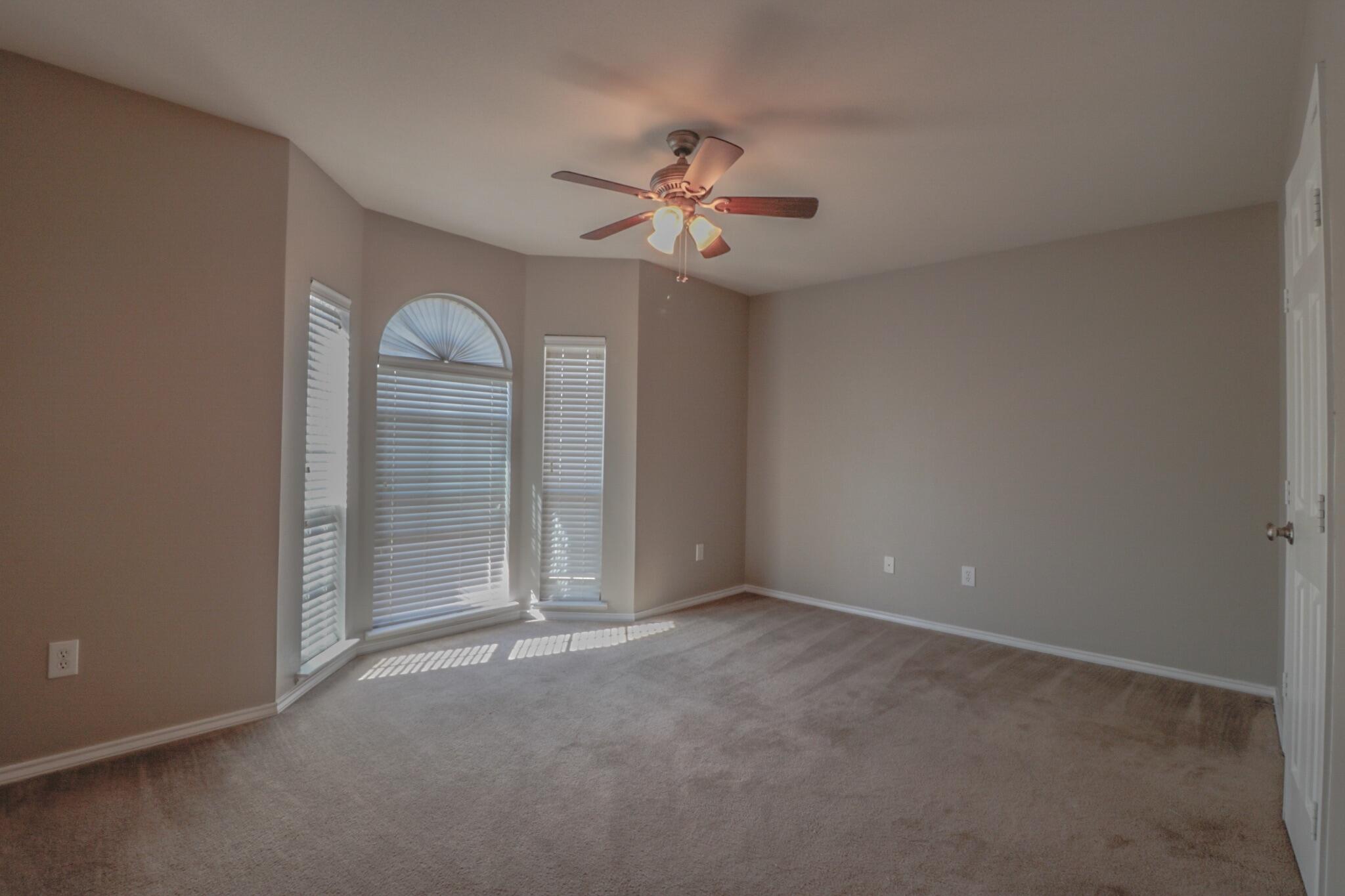 6808 88th Street Lubbock, TX 79424 - Photo 9 of 17 an empty room with closet and a ceiling fan