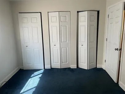 an empty room with closet area