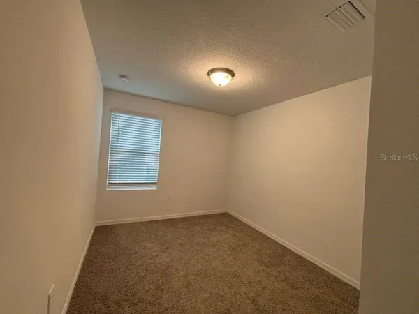 an empty room with a empty space and a window