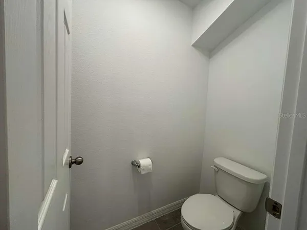 a white toilet sitting next to a shower