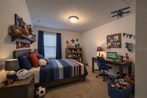 a bedroom with a bed and a bookshelf